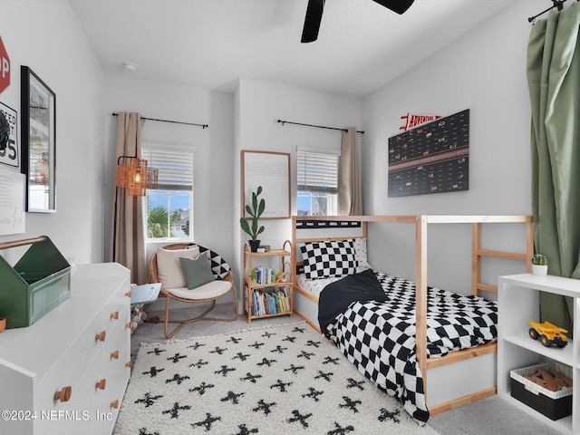 carpeted bedroom featuring multiple windows and ceiling fan