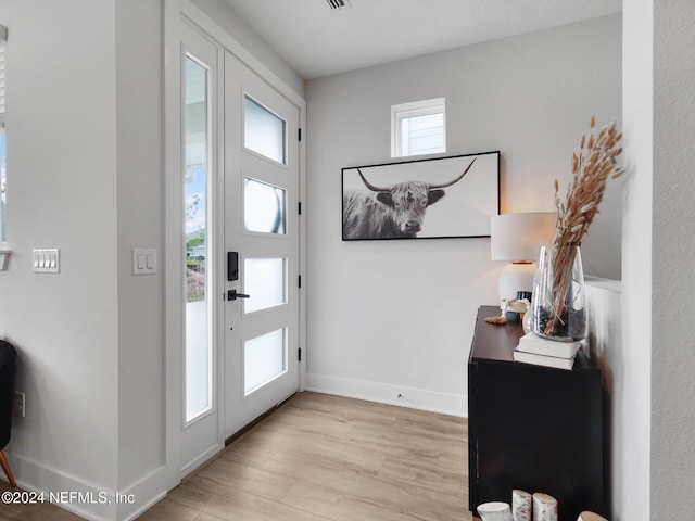 foyer entrance with light wood-type flooring