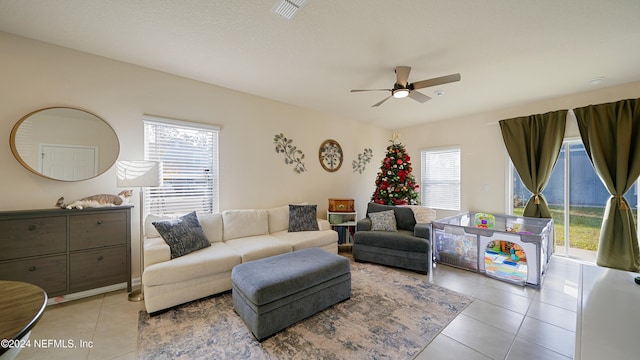 tiled living room with ceiling fan