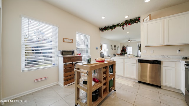 kitchen featuring ceiling fan, dishwasher, white cabinets, and light tile patterned floors