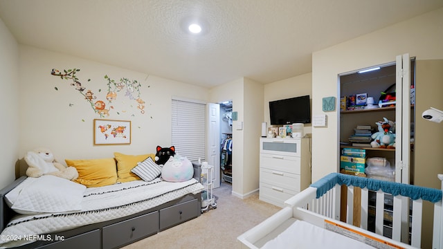 carpeted bedroom with a textured ceiling