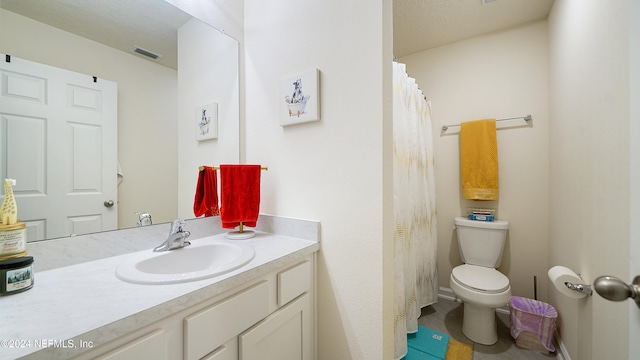 bathroom with tile patterned floors, vanity, and toilet