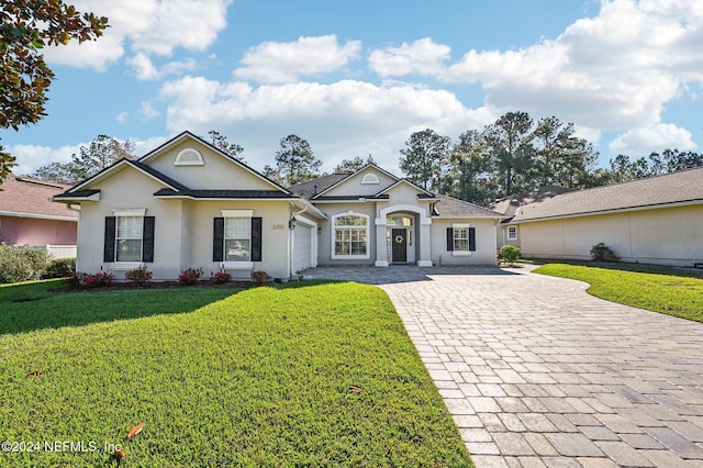 single story home featuring a front yard and a garage