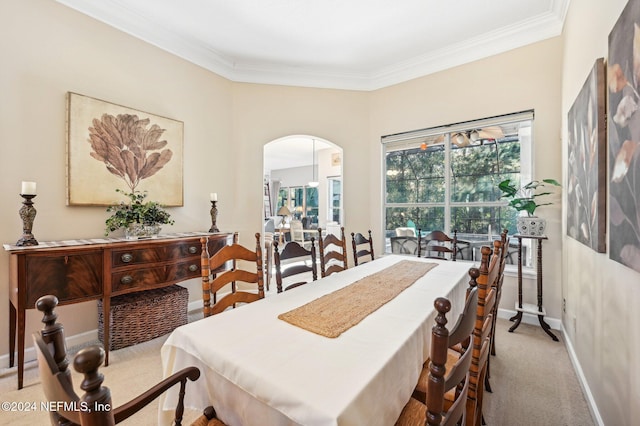 dining room featuring light colored carpet and ornamental molding