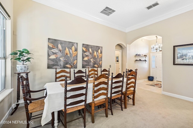 dining area featuring light colored carpet and crown molding