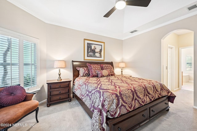 bedroom featuring light colored carpet, ceiling fan, ornamental molding, and ensuite bathroom