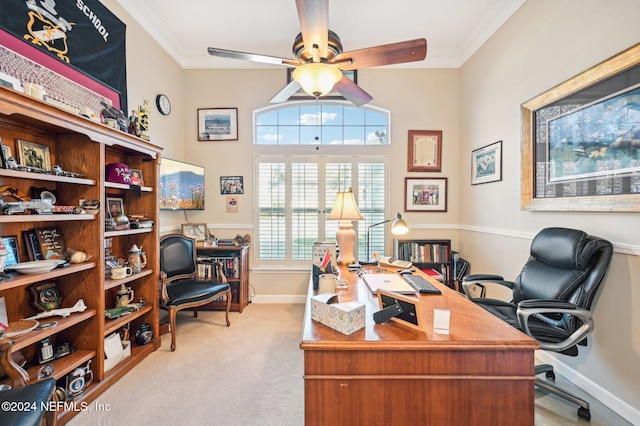 office space featuring ceiling fan, light colored carpet, a healthy amount of sunlight, and ornamental molding