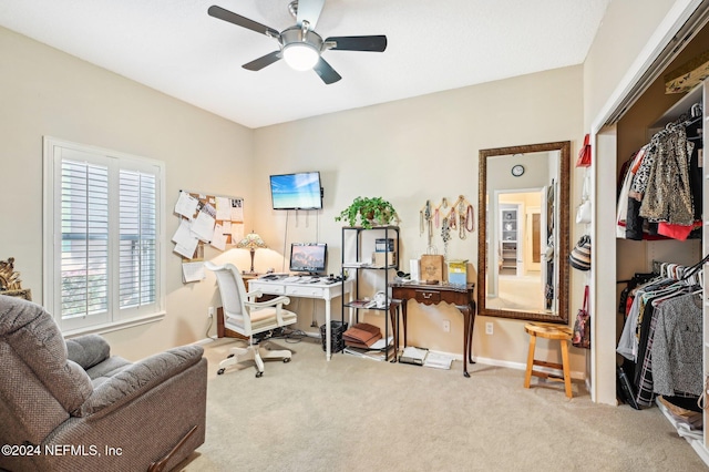 office area featuring ceiling fan and light carpet