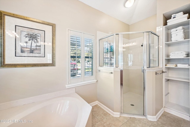 bathroom featuring tile patterned flooring and plus walk in shower