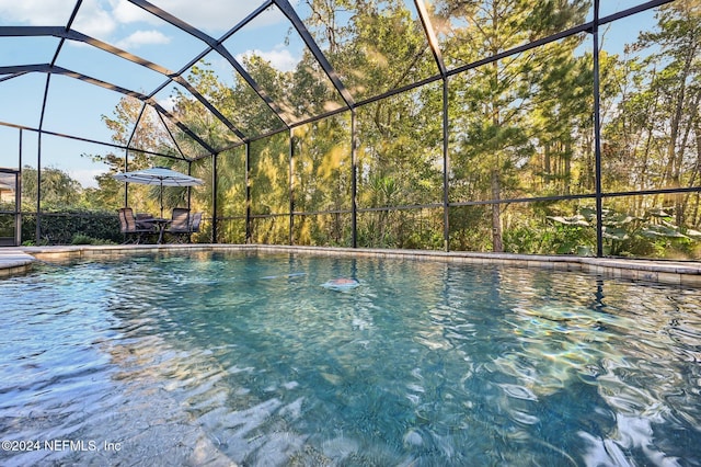 view of swimming pool with a lanai