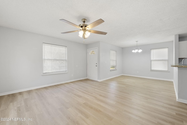 unfurnished living room featuring light hardwood / wood-style flooring and a wealth of natural light