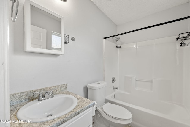 full bathroom with vanity, toilet, a textured ceiling, and bathtub / shower combination