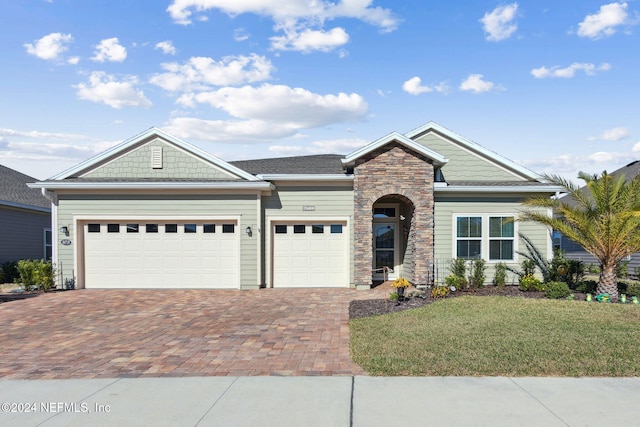 view of front facade with a garage and a front lawn