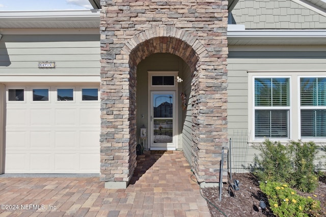 doorway to property with a garage