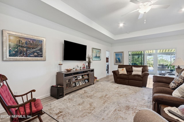 living room featuring wood-type flooring and ceiling fan