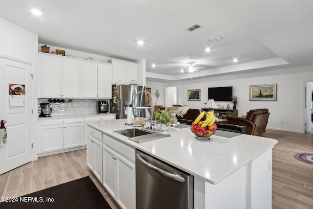 kitchen featuring white cabinetry, light hardwood / wood-style flooring, an island with sink, and stainless steel appliances