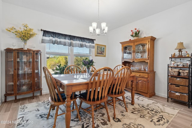 dining space with a notable chandelier and light wood-type flooring