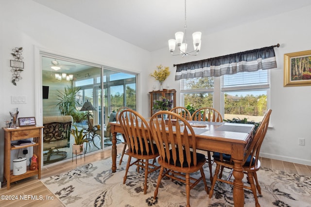 dining space featuring hardwood / wood-style floors and a notable chandelier