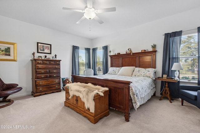 bedroom featuring ceiling fan and light carpet