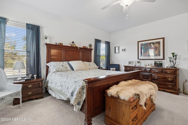 carpeted bedroom featuring ceiling fan and multiple windows