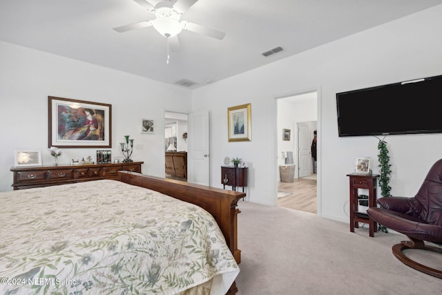 carpeted bedroom featuring ensuite bathroom and ceiling fan