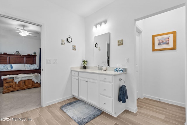 bathroom featuring hardwood / wood-style floors, vanity, and ceiling fan