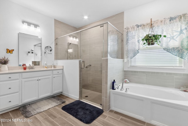 bathroom with plus walk in shower and vanity