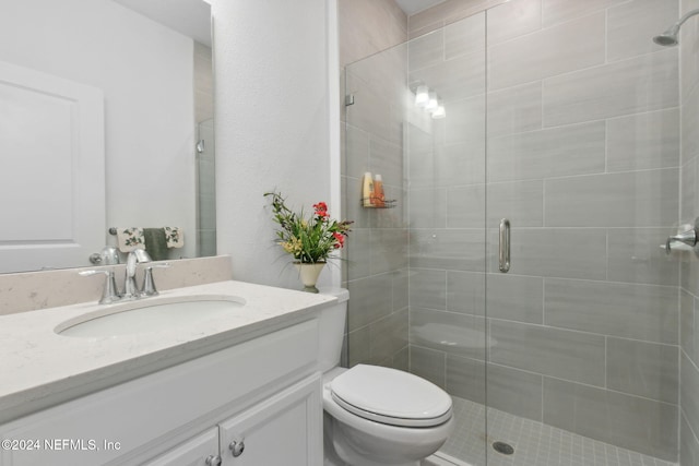 bathroom featuring vanity, toilet, and walk in shower