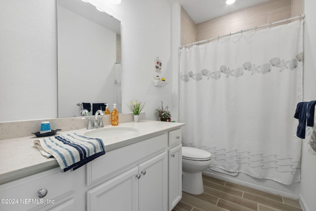 full bathroom with shower / bath combo with shower curtain, vanity, and toilet