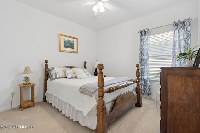 bedroom featuring light colored carpet and ceiling fan