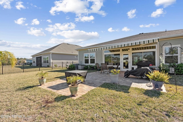 rear view of property with a patio area and a yard