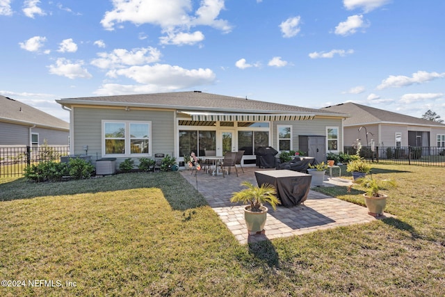 rear view of house with a patio area and a lawn