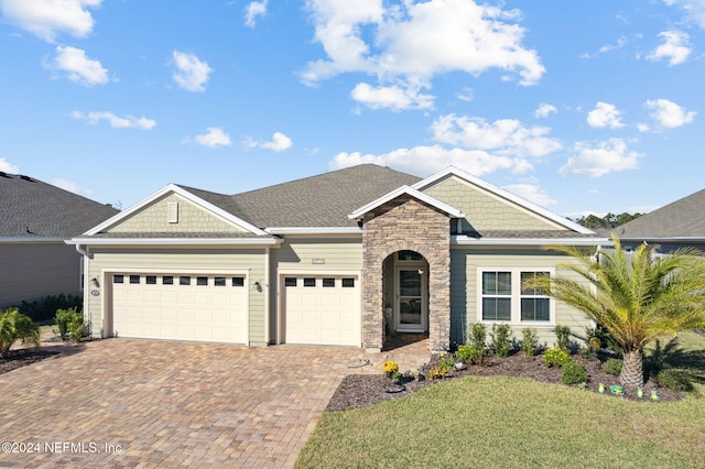 view of front facade with a front yard and a garage