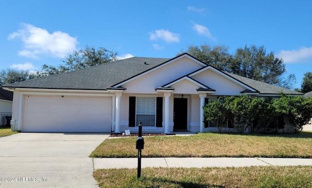 ranch-style home with a front lawn and a garage