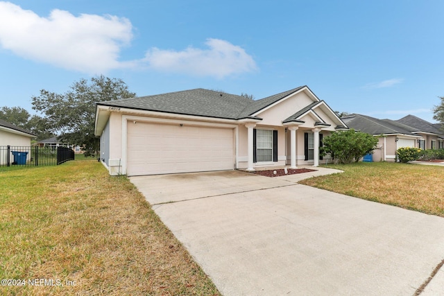 view of front of house with a front yard and a garage