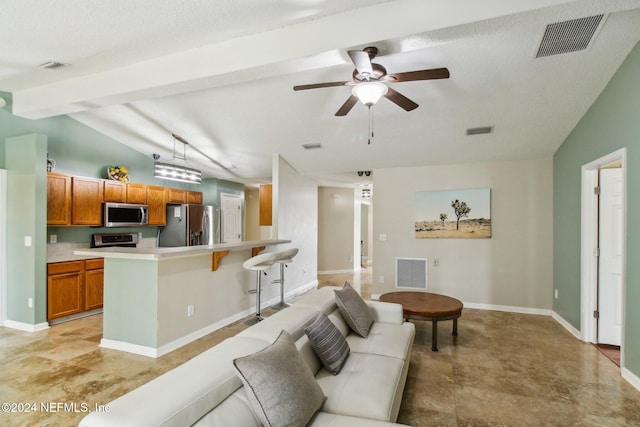 living room with vaulted ceiling with beams, ceiling fan, and a textured ceiling