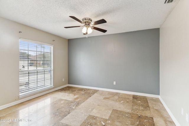 spare room with ceiling fan and a textured ceiling