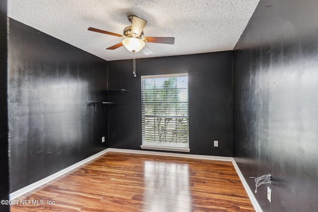 unfurnished room featuring wood-type flooring, a textured ceiling, and ceiling fan