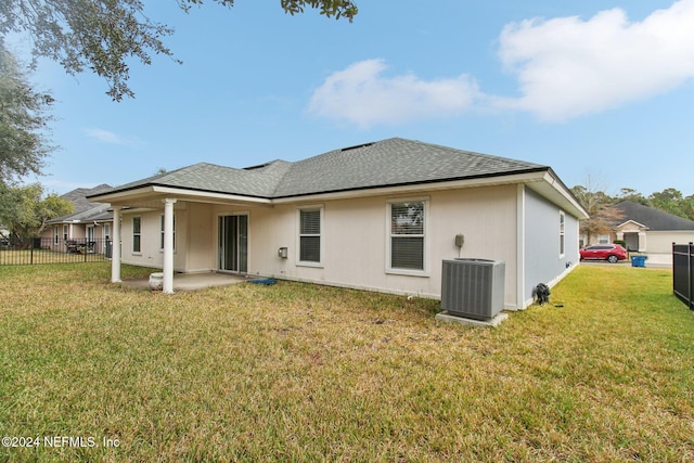 rear view of house with a yard, central AC, and a patio area