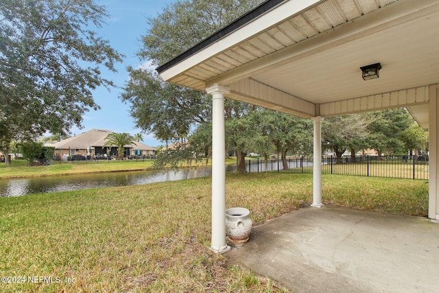 view of yard featuring a water view and a patio area