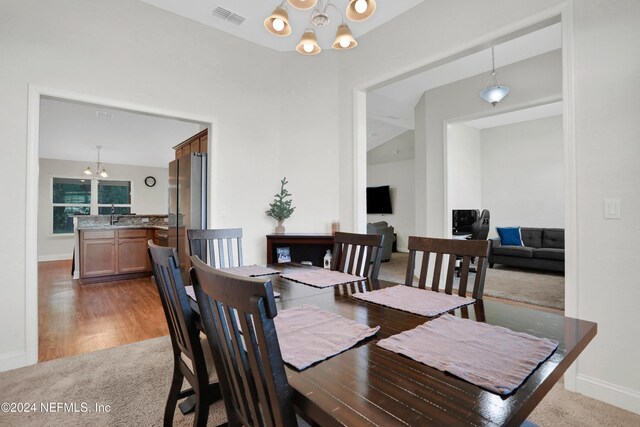 dining space featuring a chandelier and light hardwood / wood-style floors