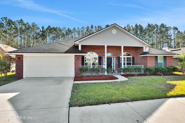 single story home featuring covered porch, a garage, and a front yard