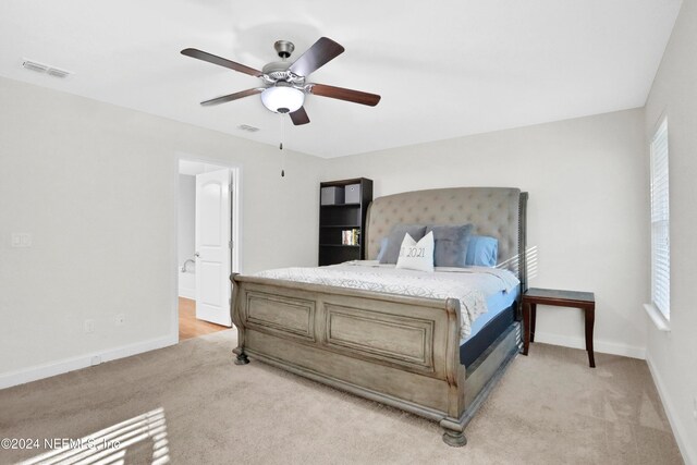 bedroom with light colored carpet and ceiling fan