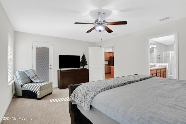 carpeted bedroom featuring ceiling fan and connected bathroom