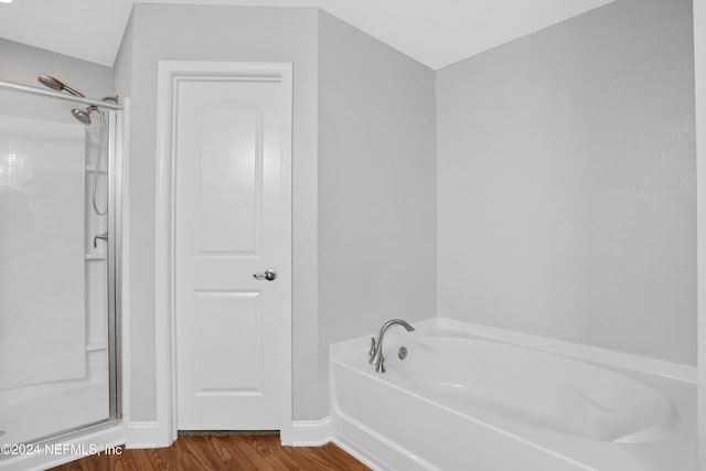 bathroom with plus walk in shower and hardwood / wood-style flooring