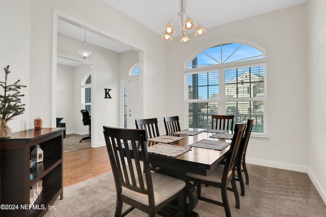 dining room featuring a chandelier and carpet flooring