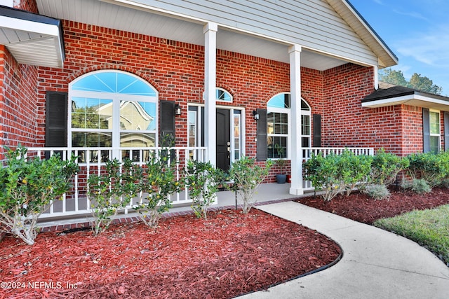 property entrance featuring covered porch