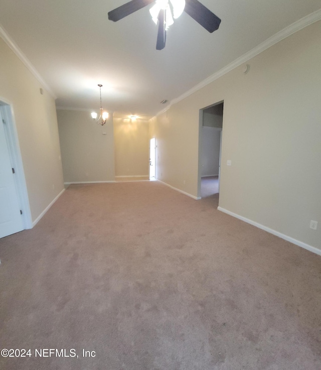 carpeted spare room with ceiling fan with notable chandelier and ornamental molding