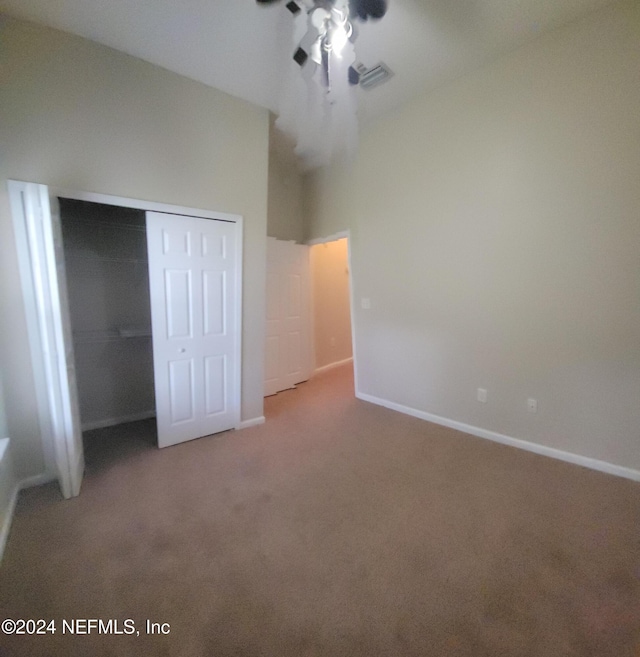 unfurnished bedroom with a closet and carpet