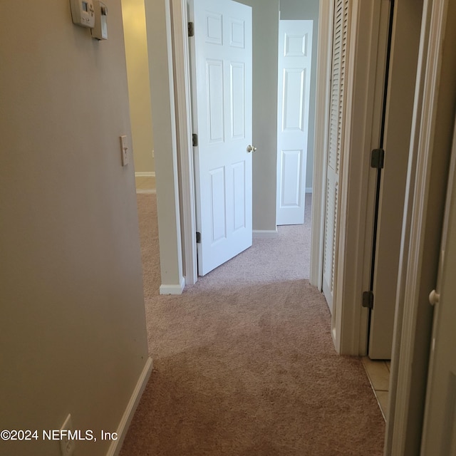 hallway featuring light carpet